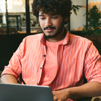 Man with curly hair on computer