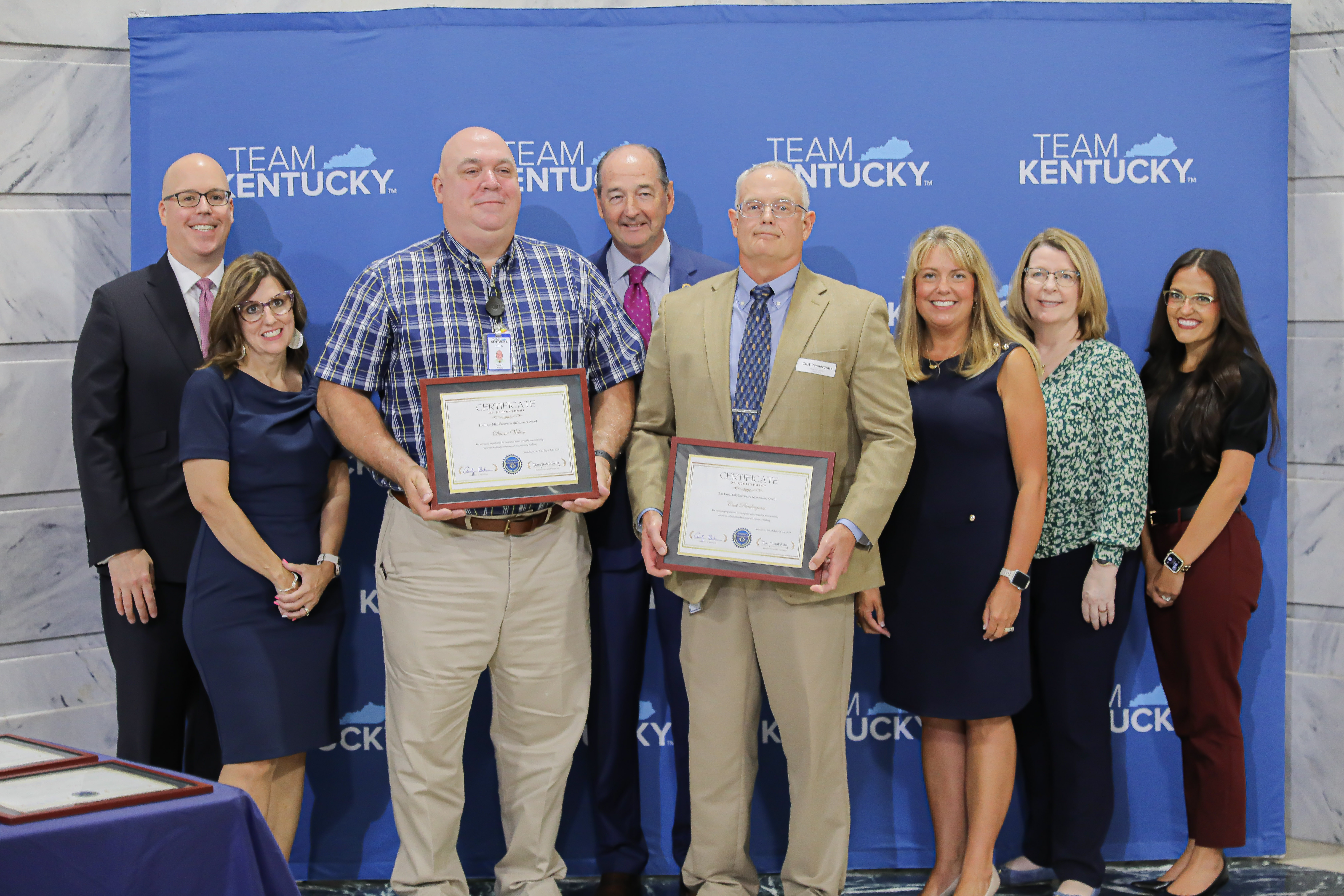 Andrea Queen, Cabinet for Health and Family Services recieving the Leadership Award from Governor andy Beshear and Sec. Bailey