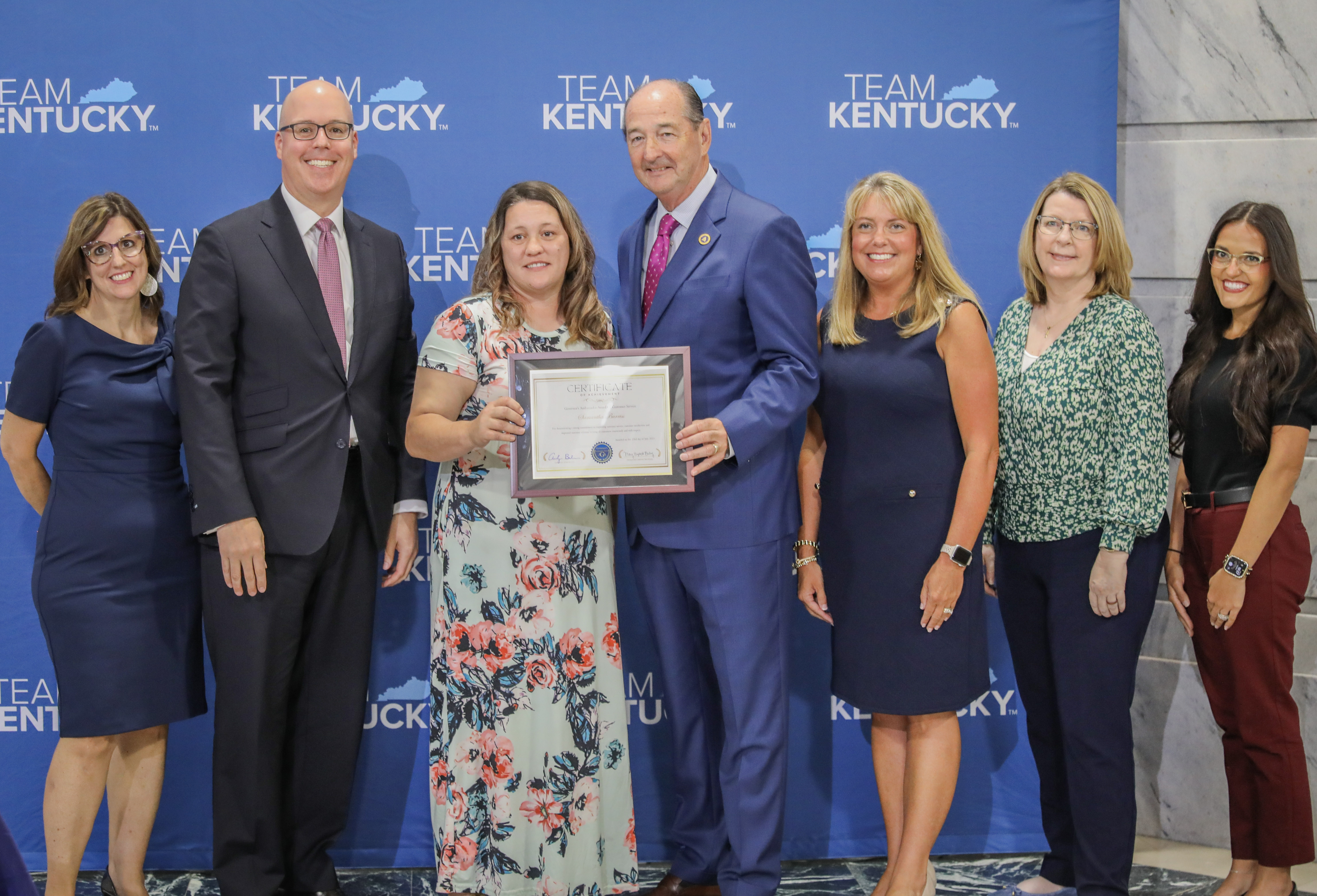 Heather Campbell and Meagan Dunn, Department for Juvenile Justice recieving the Customer Service Award from Gov. Andy Beshear 