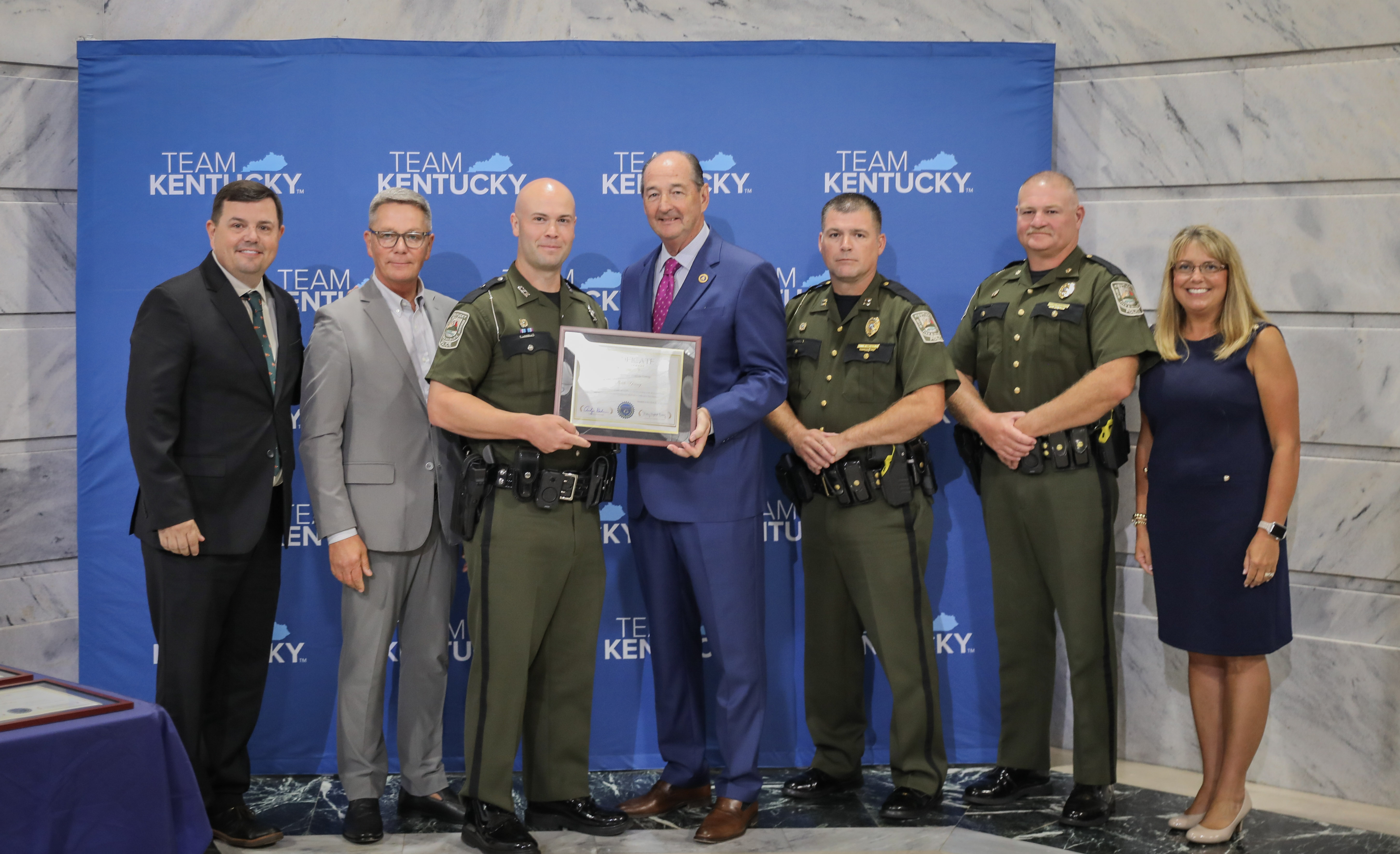 Jason Keaton, Energy and Environment Cabinet reccieving the Courage Award from Gov. Andy Beshear and Secretary Bailey